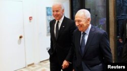 Israel's President Shimon Peres (right) walks with U.S. Vice President Joe Biden before their meeting at Peres' residence in Jerusalem in January.