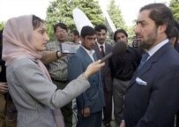 An Afghan journalist interviews Afghan Foreign Minister Abdullah Abdullah in 2002 (AFP)