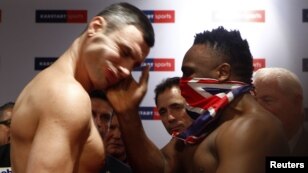 British boxer Dereck Chisora slaps the face of Ukrainian heavyweight WBC boxing champion Vitali Klitschko at the official weigh-in in Munich ahead of their fight on February 18.