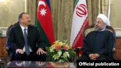 Iran's President Hassan Rohani (right) officially welcomes his Azeri counterpart, Ilham Aliyev, in Tehran on April 9.