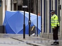A policeman guards a tent covering the car near London's busy Piccadilly Circus (AFP)