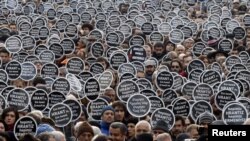 Protesters gather in front of the "Agos" newspaper office during a demonstration to mark the fifth anniversary of the killing of Turkish-Armenian editor Hrant Dink in Istanbul in January 2012.