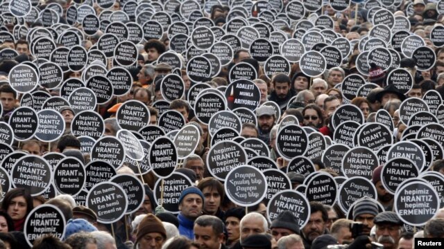 Protesters gather in front of the "Agos" newspaper office during a demonstration to mark the fifth anniversary of the killing of Turkish-Armenian editor Hrant Dink in Istanbul in January 2012.