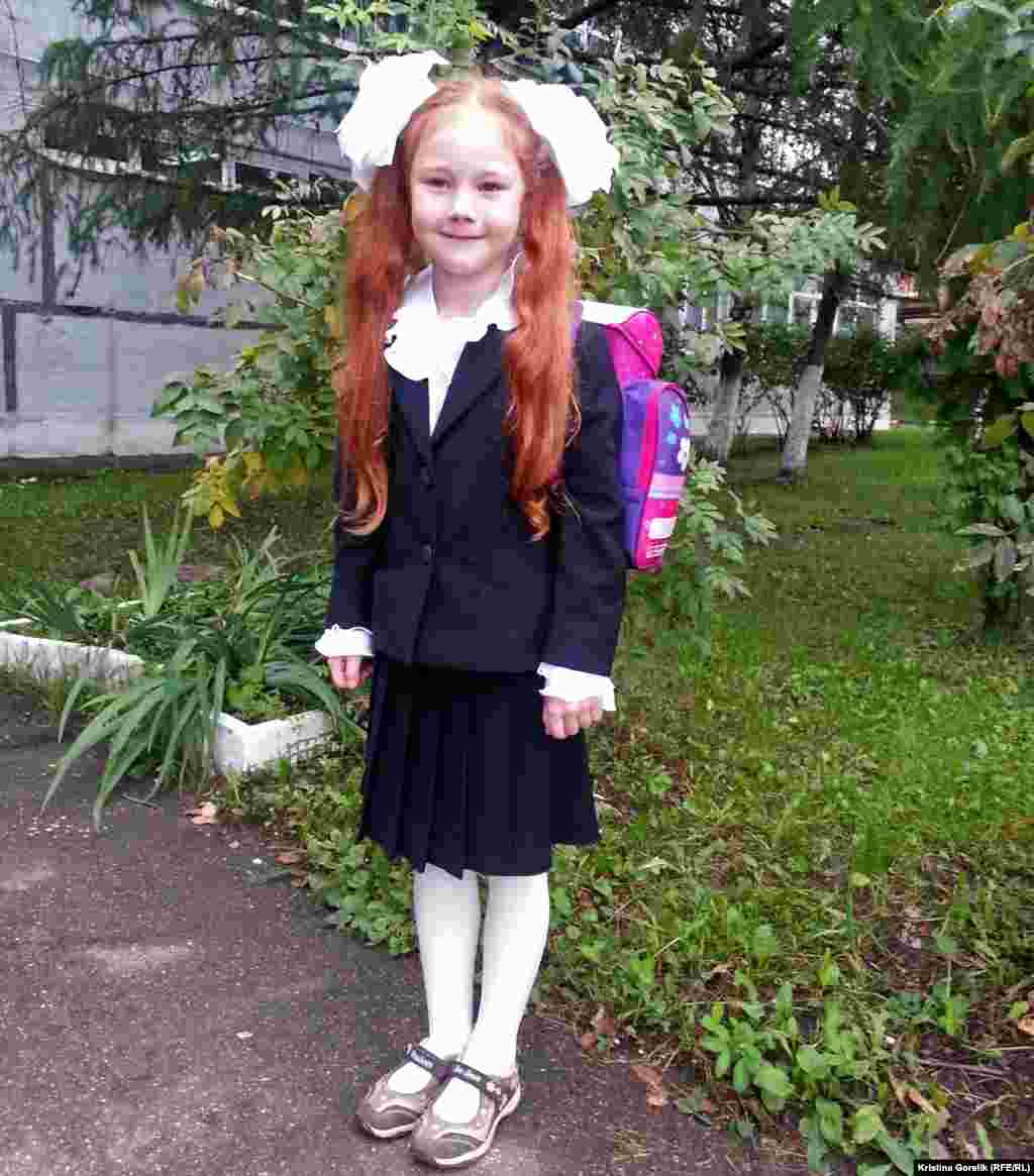 A girl poses before the first day of school in Moscow, Russia.