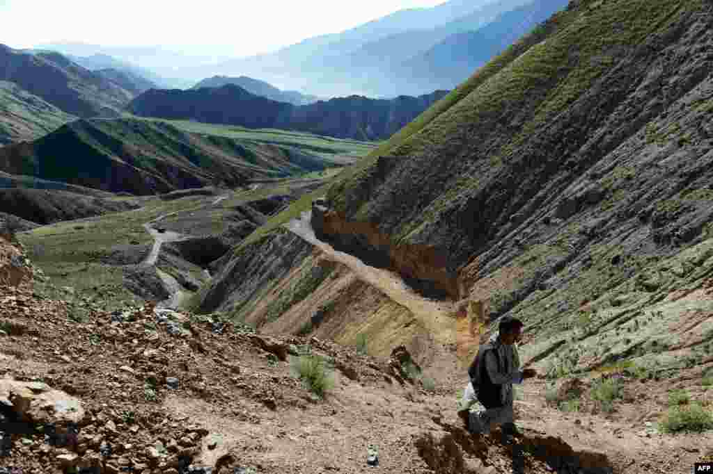 Afghan miner Morad Ali walks on a mountainside near the village of Qara Zaghan in Baghlan Province.