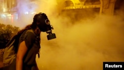 A protester wears a gas mask during clashes with police near Taksim Square in Istanbul in June.