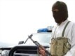 A masked tribesman patrols near Wana, in South Waziristan, where torrid fighting that pitted tribesmen against Uzbek and other foreign militants in March 2007 left more than 100 dead