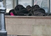 Two homeless men lie on a ventilation duct in Moscow as temperatures in Russia plunge, 18 January (epa)
