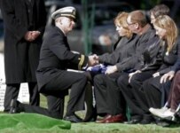 Chaplain Ron Nordan (left) shakes hands with Jim Walsh at the funeral of his son, Marine Corps Sergeant Justin Walsh, at Arlington National Cemetery in Arlington, Virginia (file photo) 
