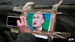 Russian President Vladimir Putin's snarling visage has become the main target for caricatures and cartoons.