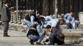Turkish forensic police officers inspect the scene of the blast in Ankara.
