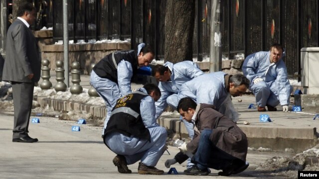 Turkish forensic police officers inspect the scene of the blast in Ankara.
