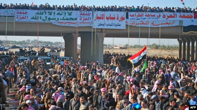 Iraqi protesters pray during a demonstration in Ramadi, capital of the western region of Anbar, on December 28.