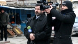 Sahar TV correspondent Anar Bayramli (left) had a year cut from his sentence.