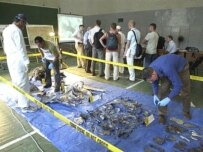 Weapons experts inspect the remains of the missile in Tbilisi (AFP)
