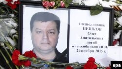A portrait of Russian pilot Oleg Peshkov lies among flowers outside the Russian Defense Ministry building in Moscow last week.