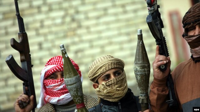 Armed Sunni fighters take up positions in Fallujah on January 5.