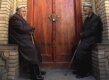 Two men wait for a mosque to open.