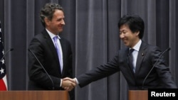 U.S. Treasury Secretary Timothy Geithner (left) shakes hands with Japan's Finance Minister Jun Azumi during a joint news conference at the Finance Ministry in Tokyo on January 12.