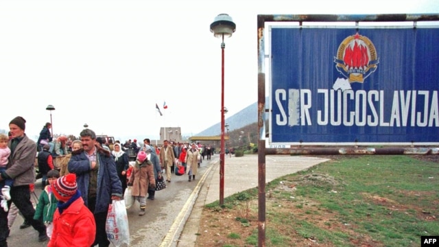 Kosovar refugees cross the border between Yugoslavia and Albania in April 1999.