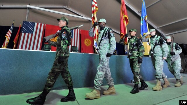 Kyrgyz soldiers parade together with U.S. servicemen during a change of command ceremony  at the U.S. transit center at Manas Airport in June. Russia has long been unhappy about the United States' presence in Kyrgyzstan. 