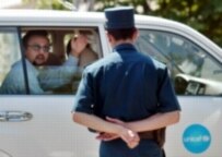 A UNICEF vehicle passes a policeman in Andijon