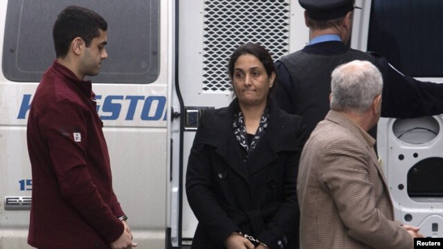 Mohammad Shafia, his wife Tooba Mohammad Yahya, and their son Hamed (right to left) arrive at the Kingston, Ontario, courthouse on January 26.