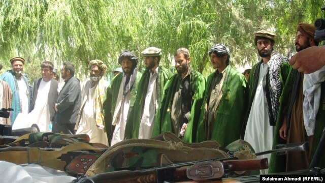 Taliban militants lay down their arms in the Baghlan Province in May