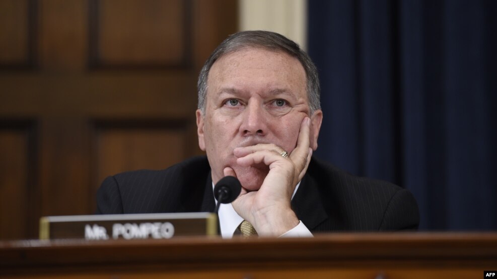U.S. Representative Mike Pompeo listens as former U.S. Secretary of State and Democratic presidential hopeful Hillary Clinton testifies before the House Select Committee on Benghazi in Washington, D.C., in October 2015.