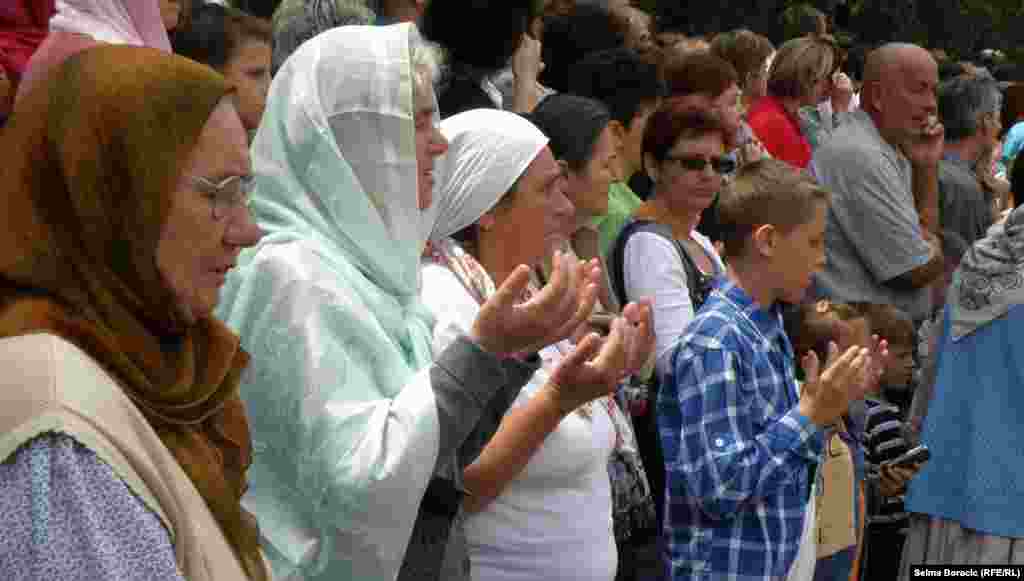 Some people prayed as the trucks drove by.