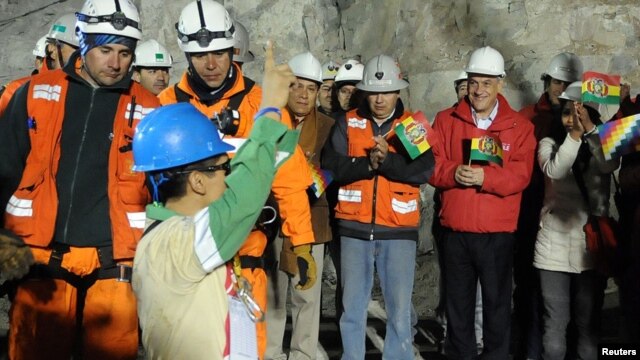 Bolivian national Carlos Mamani celebrates as he arrives as the fourth miner to be hoisted to the surface in Copiapo on October 13.