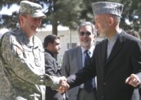 Eikenberry (left) shakes hands with President Karzai at a ceremony in October 2006 (epa)