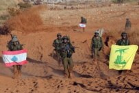 Israeli soldiers carrying Lebanese and Hizballah flags as they march back to Israel on August 14 (epa)