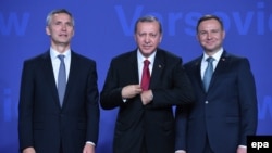 Polish President Andrzej Duda (right) and NATO Secretary General Jens Stoltenberg (left) welcome Turkish President Recep Tayyip Erdogan (center) at the opening of the NATO Summit in Warsaw on July 8.