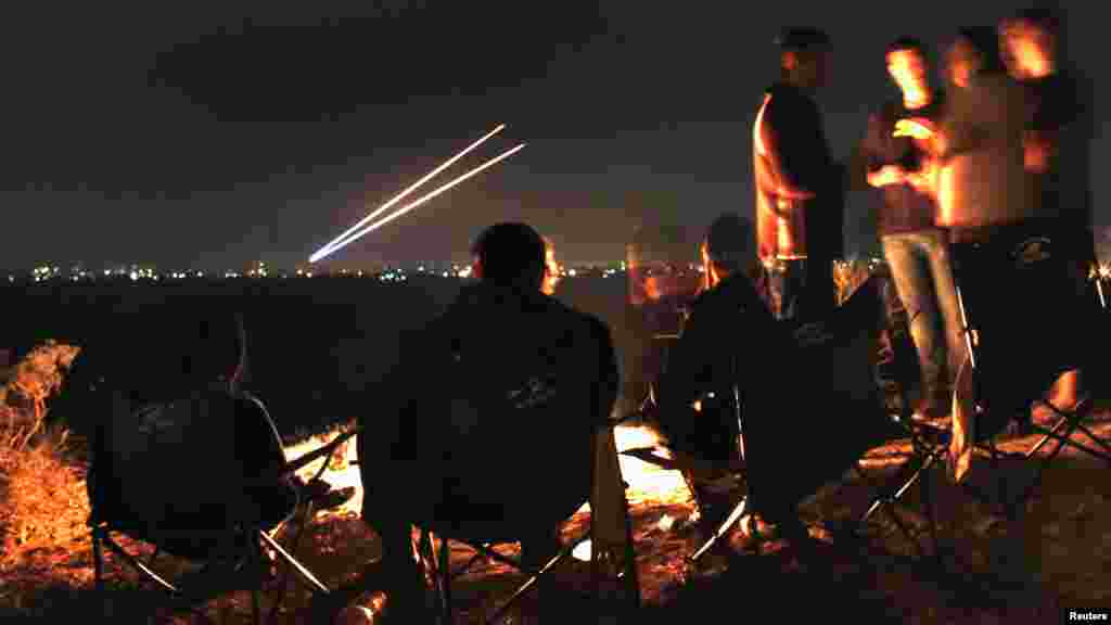 Israeli civilians sitting atop a hill in the city of Sderot watch as two Palestinian rockets fly toward southern Israel before a cease-fire on November 21. Israel and the Islamist Hamas movement ruling the Gaza Strip agreed to an Egyptian-sponsored cease-fire to halt an eight-day conflict that killed 162 Palestinians and five Israelis. (Reuters/Yannis Behrakis)