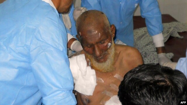 Medical staff treat a victim following twin bomb attacks in northwestern Pakistan.