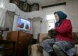 An Russian pensioner in the village of Andreyevskoe watches President Putin on national television in October (epa)