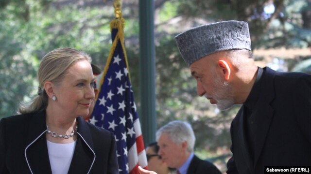 U.S. Secretary of State Hillary Clinton (left) speaks as Afghan President Hamid Karzai listens during a press conference at the presidential palace in Kabul on July 7.