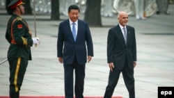 Afghan President Ashraf Ghani (right) and Chinese President Xi Jinping (center) review a guard of honor during a welcoming ceremony outside the Great Hall of the People in Beijing, China, on October 28.
