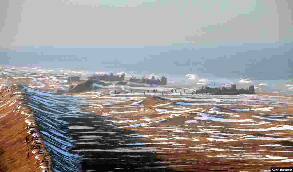 A state image of soldiers of the Korean People's Army taking part in landing and antilanding drills in North Korea. Western media subsequently speculated that the photo had been doctored to include more hovercraft than were actually present. (Reuters/KCNA)