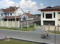 A boy riding a bicycle among new homes outside Moscow (ITAR-TASS)
