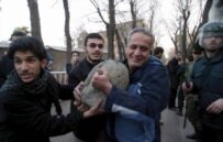 A demonstrator prepares to throw a rock at the Danish Embassy in Tehran during the cartoon controversy in February 2006 (epa)