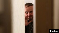 Belarusian journalist Henadz Barbarych sits in a courtroom in Minsk last April after being arrested for disobeying the police at a rally to mark the anniversary of the Chornobyl nuclear disaster.