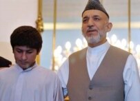 President Hamid Karzai with 14-year-old Rafiqullah at the presidential palace in Kabul on July 15 (AFP)