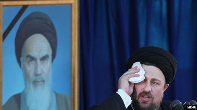 Hassan Khomeini tries to speak over the shouts of hecklers.
