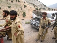 Pakistan -- Pakistani troops take rest as they travel to join others after the US air strike in the mountainous Gora Prai, 11Jun2008