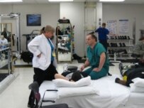 Dr. Don Gajewski (right) consults with a patient and a physical therapist at Walter Reed Army Medical Center (RFE/RL)