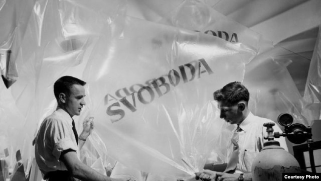 Two RFE/RL employees prepare balloons which will carry leaflets into Czechoslovakia. (1951)