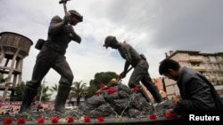 A man lays carnations at the Miners Monument in central Soma, a district in Turkey's western province of Manisa, on May 14.
