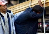 Young men grieving at the site of today's bombing (AFP)